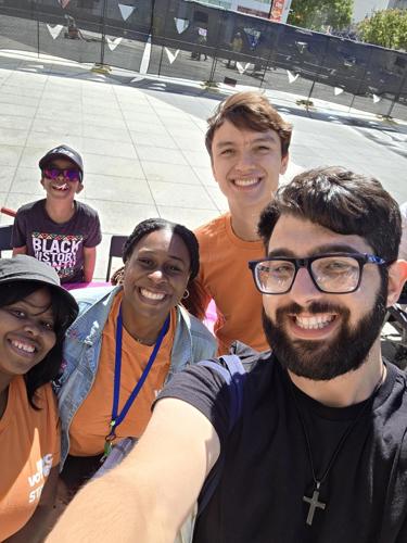 Luke takes a selfie of himself with four other NYC Votes staff volunteering at an event.