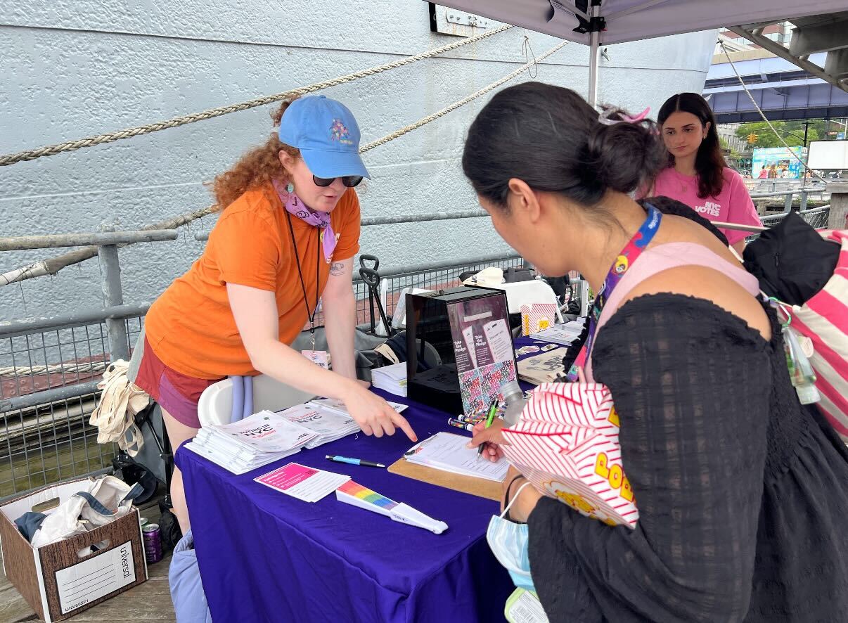 A CFB staff member talks to a potential voter at a tabling event