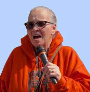 Pat Jewett speaking into a microphone at a CASA NYC event wearing an orange CASA hoodie.