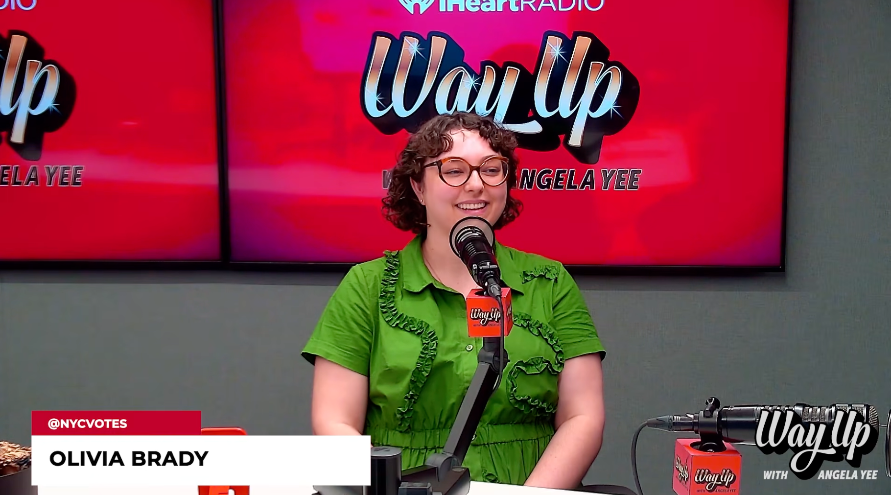 Olivia Brady sits behind a microphone in the podcast booth of Angela Yee's how, Way Up with Angela Yee
