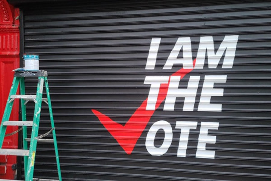 "I am the vote" painted on a gate